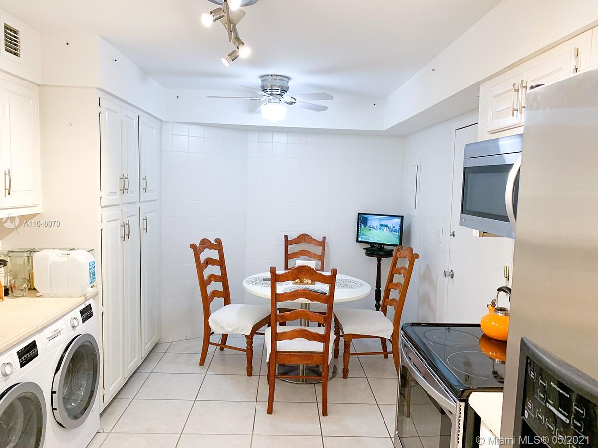 1121 Crandon Boulevard, Unit D404 Key Biscayne, FL 33149 - Photo 10 of 27 a dining room with furniture and fireplace