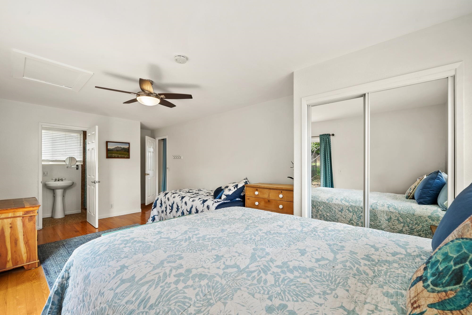 20 Pea Place Kula, HI 96790 - Photo 19 of 49 a bedroom with a bed and a chandelier