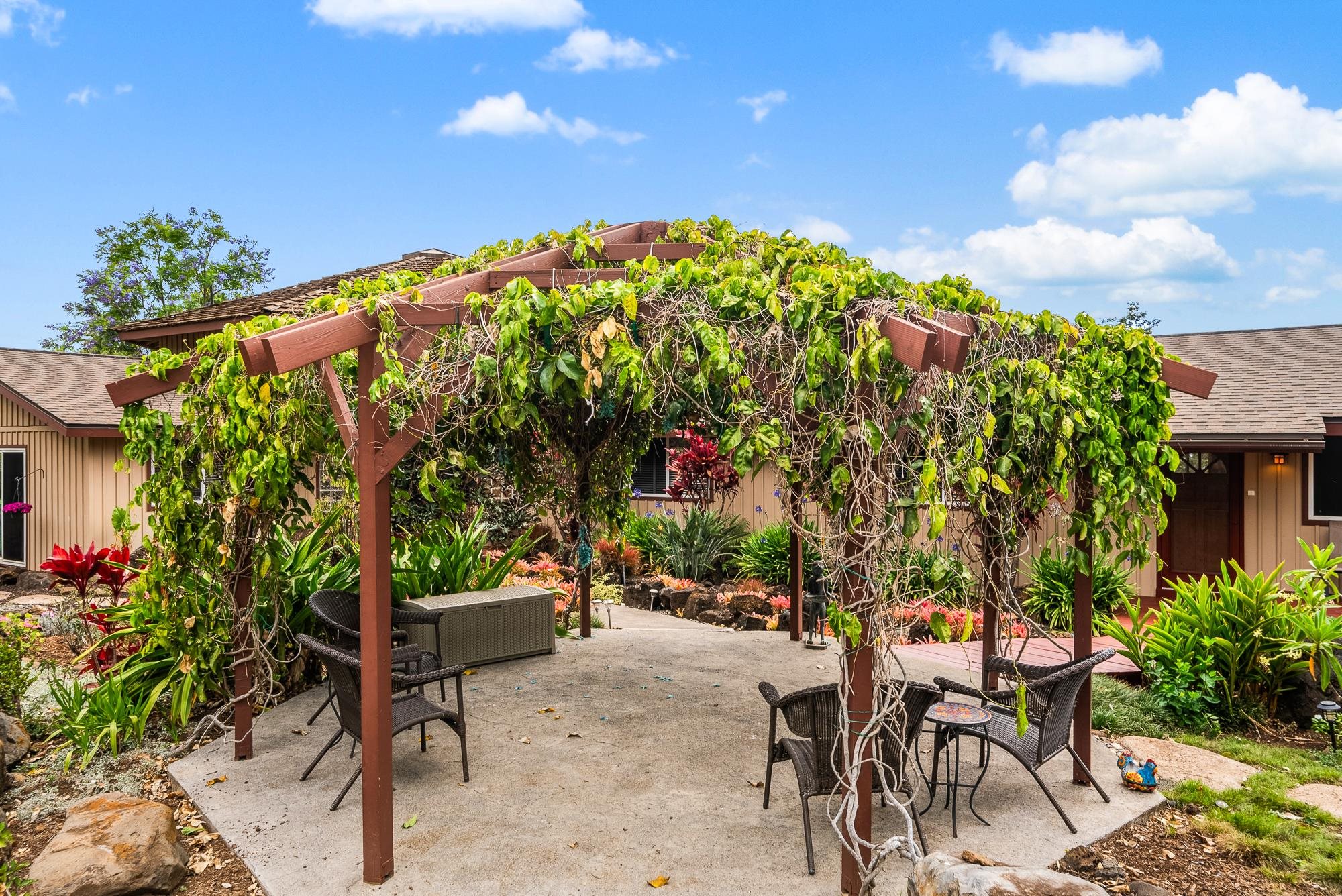 20 Pea Place Kula, HI 96790 - Photo 37 of 49 a backyard of a house with table and chairs plants