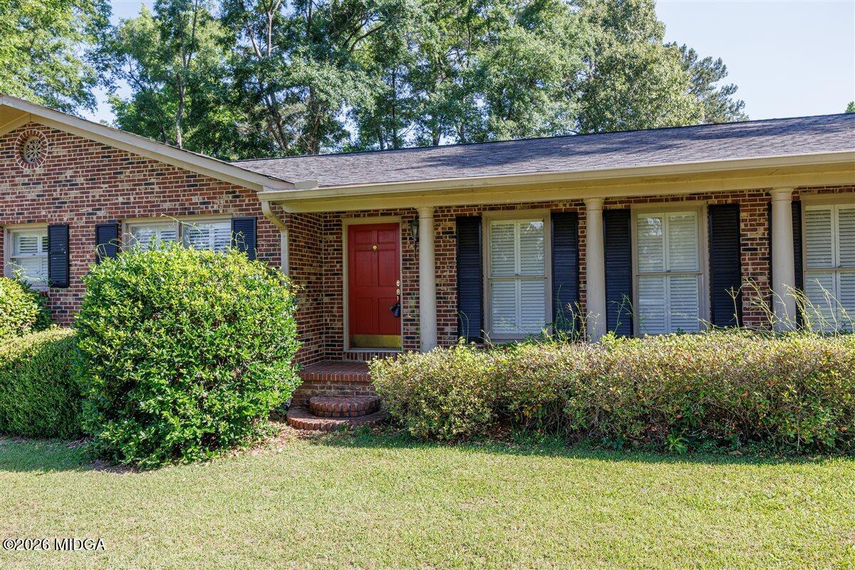 335 Hamrick Road Macon, GA 31220 - Photo 35 of 41 a view of a house with potted plants and a table and chairs