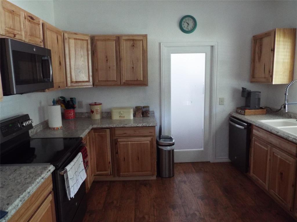 721 Midway Road Tool, TX 75143 - Photo 13 of 30 a kitchen with stainless steel appliances granite countertop a refrigerator stove and sink