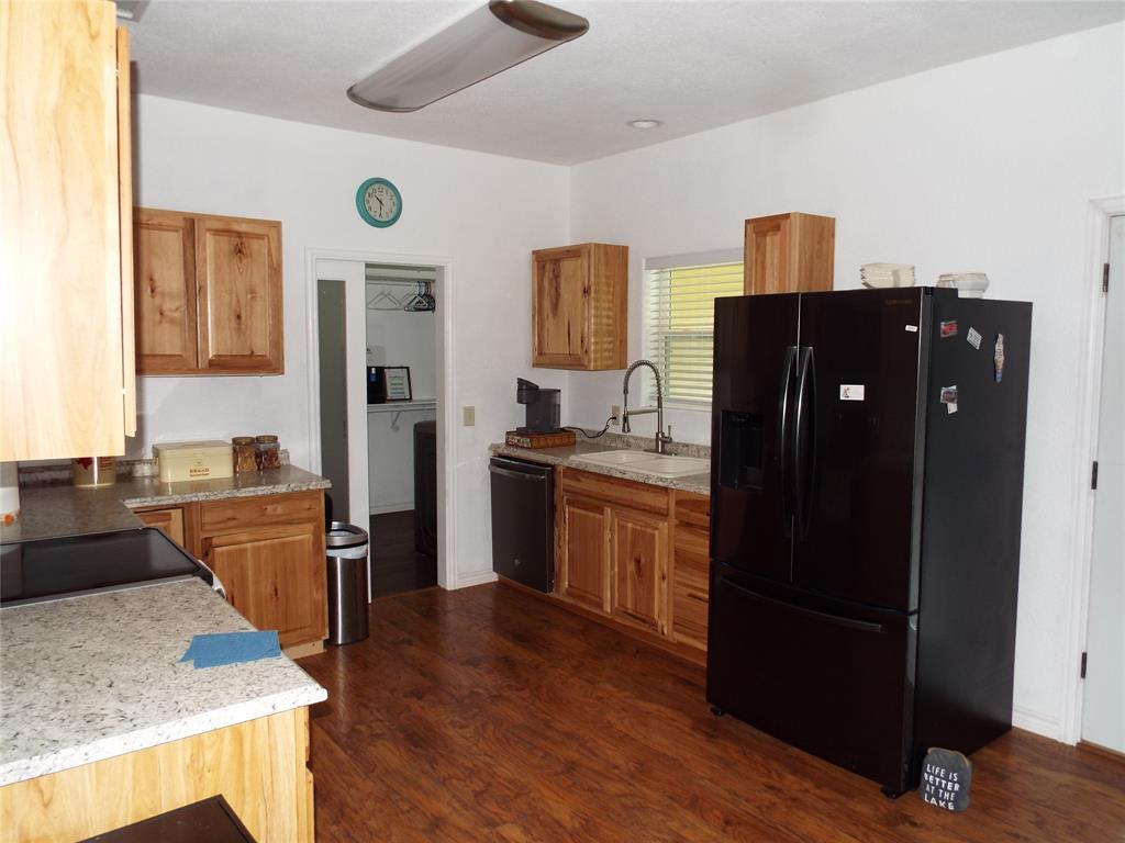 721 Midway Road Tool, TX 75143 - Photo 17 of 30 a kitchen with a refrigerator and a stove top oven