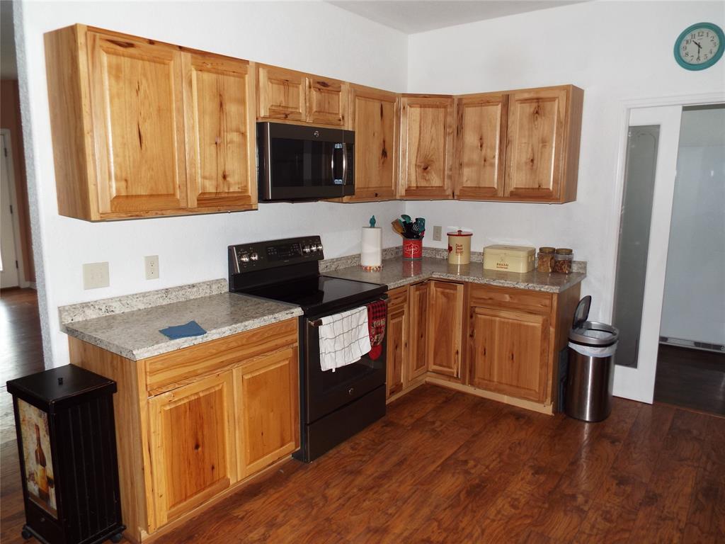 721 Midway Road Tool, TX 75143 - Photo 18 of 30 a kitchen with a sink a stove and cabinets