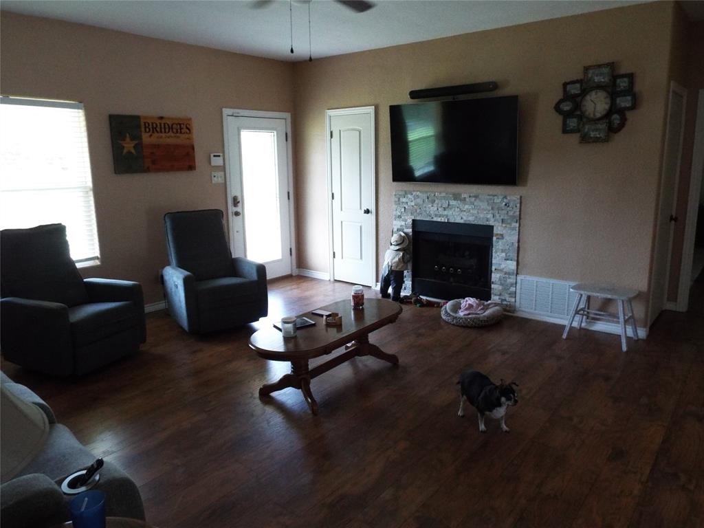 721 Midway Road Tool, TX 75143 - Photo 23 of 30 a living room with furniture a flat screen tv and a fireplace