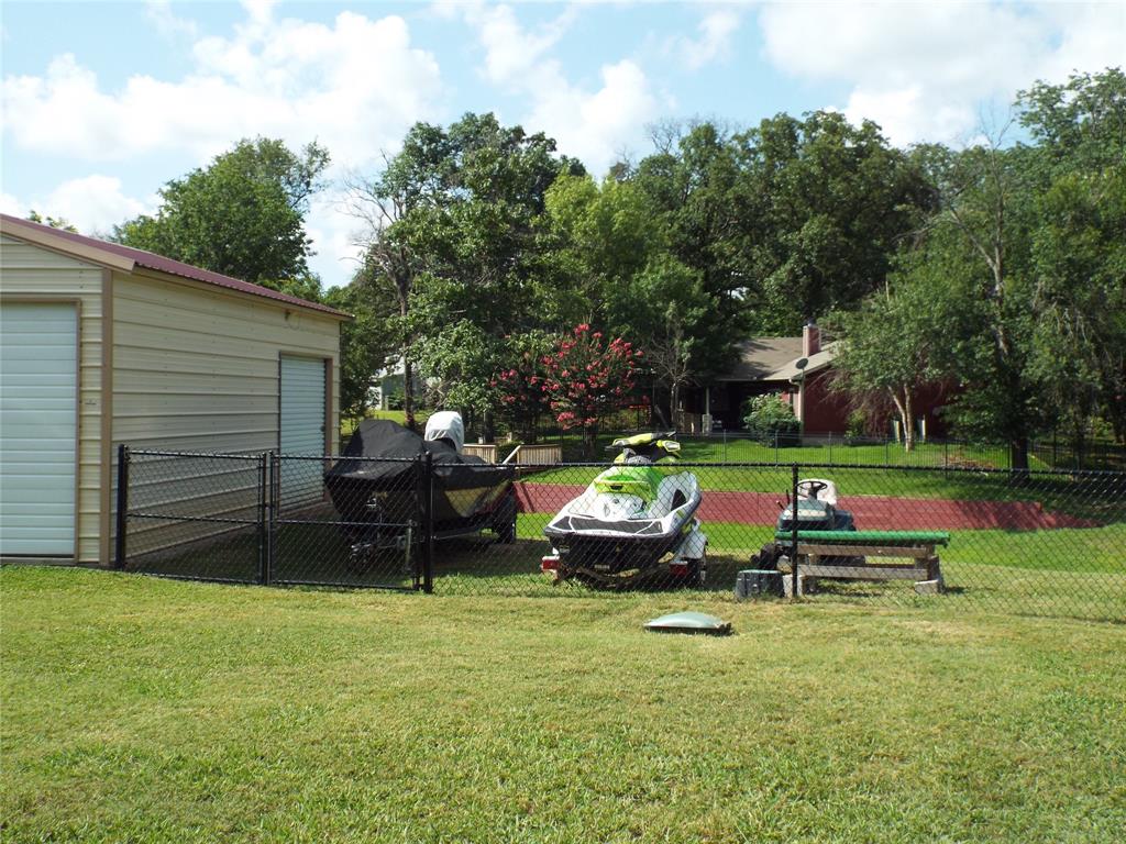 721 Midway Road Tool, TX 75143 - Photo 26 of 30 a backyard of a house with table and chairs