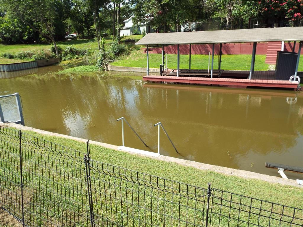 721 Midway Road Tool, TX 75143 - Photo 29 of 30 a view of a swimming pool with a lawn chairs under an umbrella