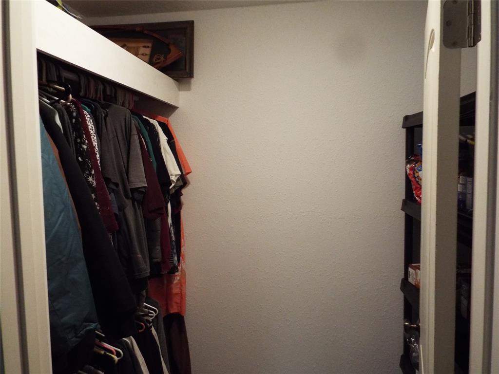 721 Midway Road Tool, TX 75143 - Photo 9 of 30 a view of walk in closet with clothes