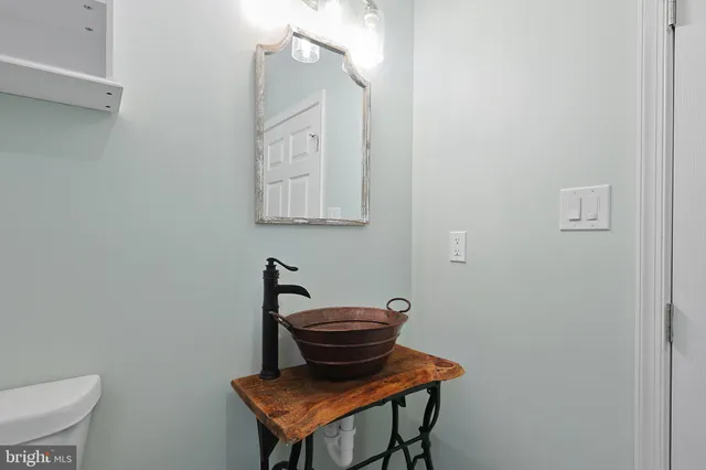 a bathroom with a toilet a sink and mirror
