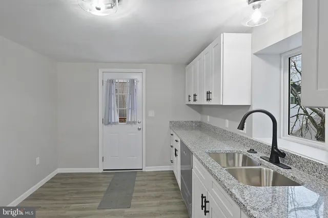 a kitchen with kitchen island stainless steel appliances sink and refrigerator