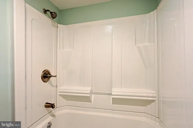a bathroom with a tub and shower