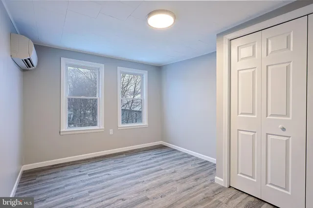 a view of an empty room with wooden floor