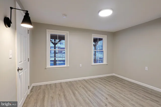 a view of an empty room with wooden floor
