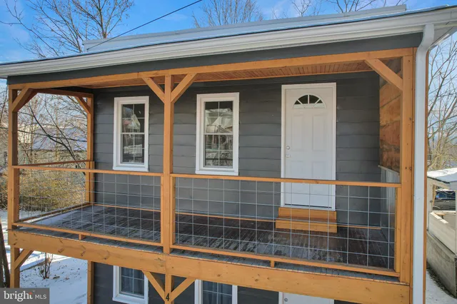 a view of a house with a yard and balcony