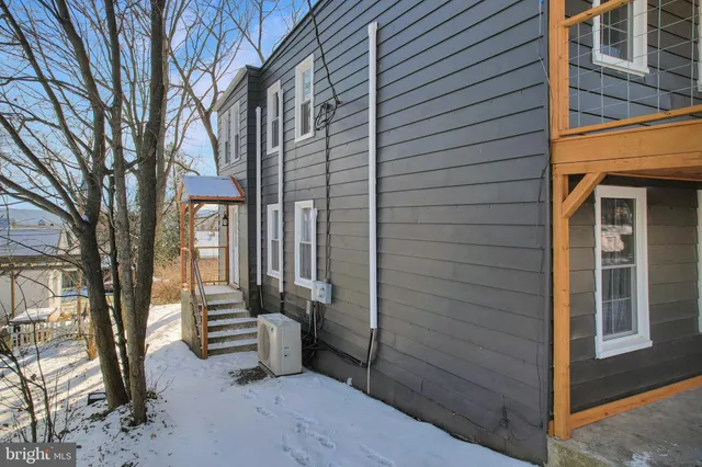 a front view of a house with outdoor seating