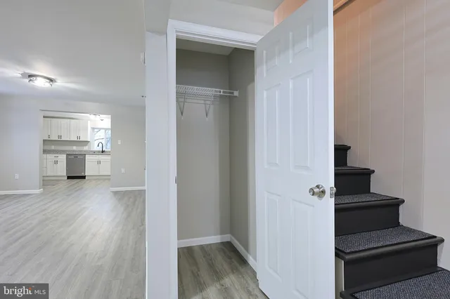 a view of a kitchen with wooden floor and a kitchen