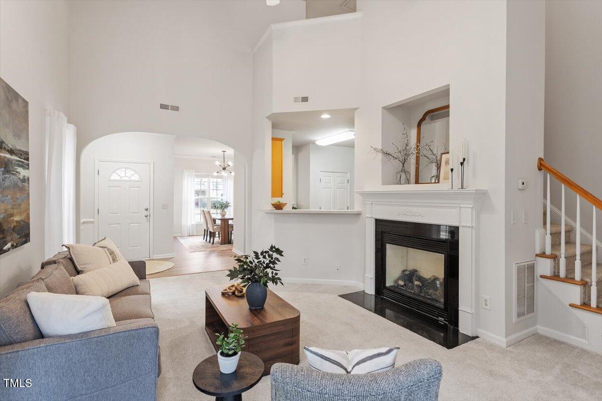 8412 Lunar Stone Place Raleigh, NC 27613 - Photo 7 of 28 a living room with furniture and a fireplace