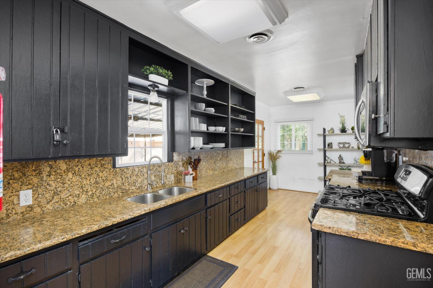 Undisclosed Address Bakersfield, CA 93312 - Photo 12 of 35 a kitchen with stainless steel appliances granite countertop a sink stove and cabinets