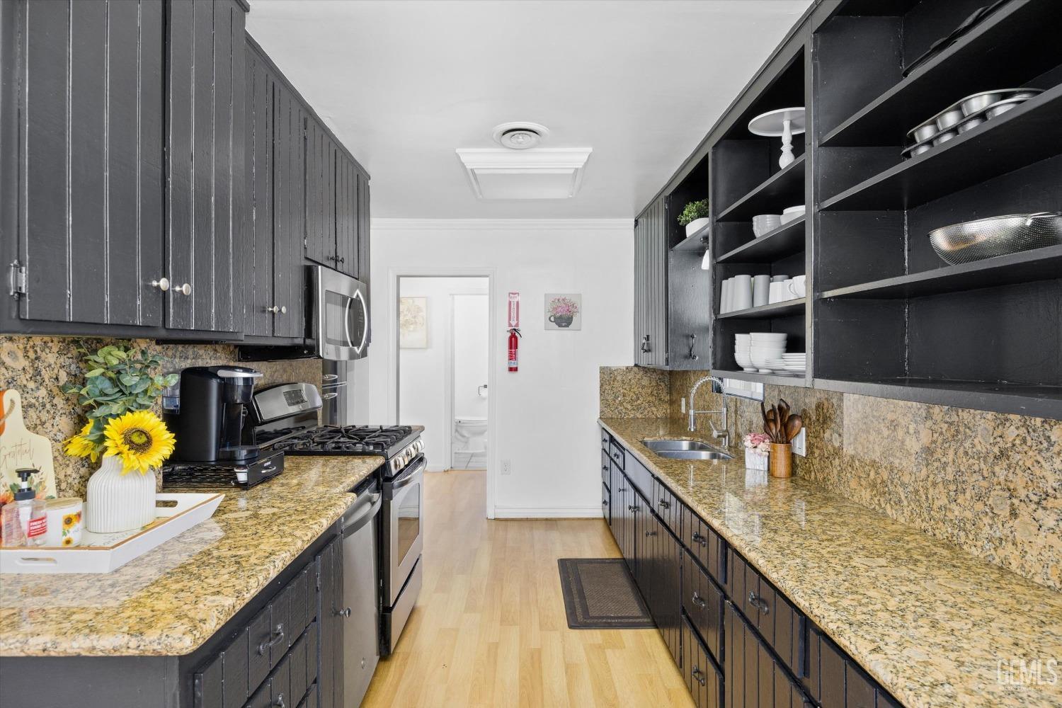 Undisclosed Address Bakersfield, CA 93312 - Photo 13 of 35 a kitchen with counter top space cabinets and stainless steel appliances