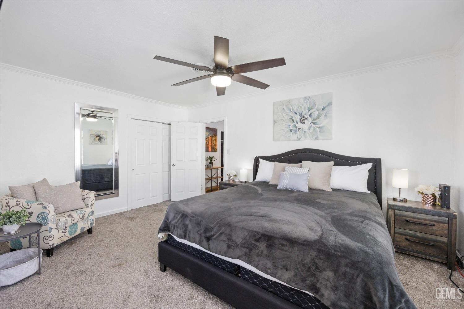 Undisclosed Address Bakersfield, CA 93312 - Photo 17 of 35 a spacious bedroom with a bed and ceiling fan