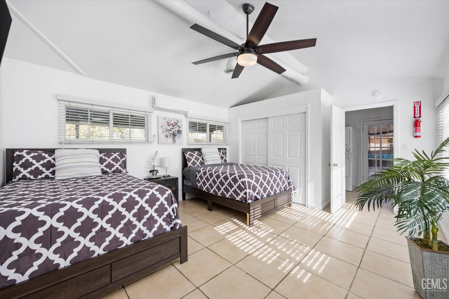 Undisclosed Address Bakersfield, CA 93312 - Photo 23 of 35 a bedroom with a large bed and a chandelier