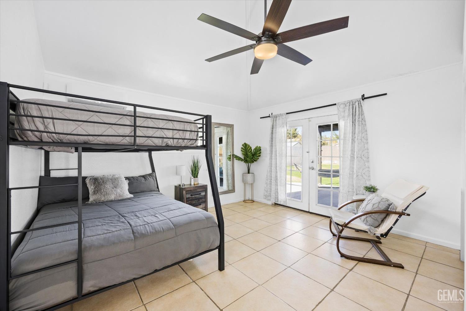 Undisclosed Address Bakersfield, CA 93312 - Photo 24 of 35 a bedroom with a bed a chair and the view of the kitchen