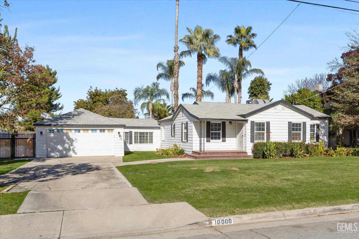 Undisclosed Address Bakersfield, CA 93312 - Photo 4 of 35 a front view of a house with a garden