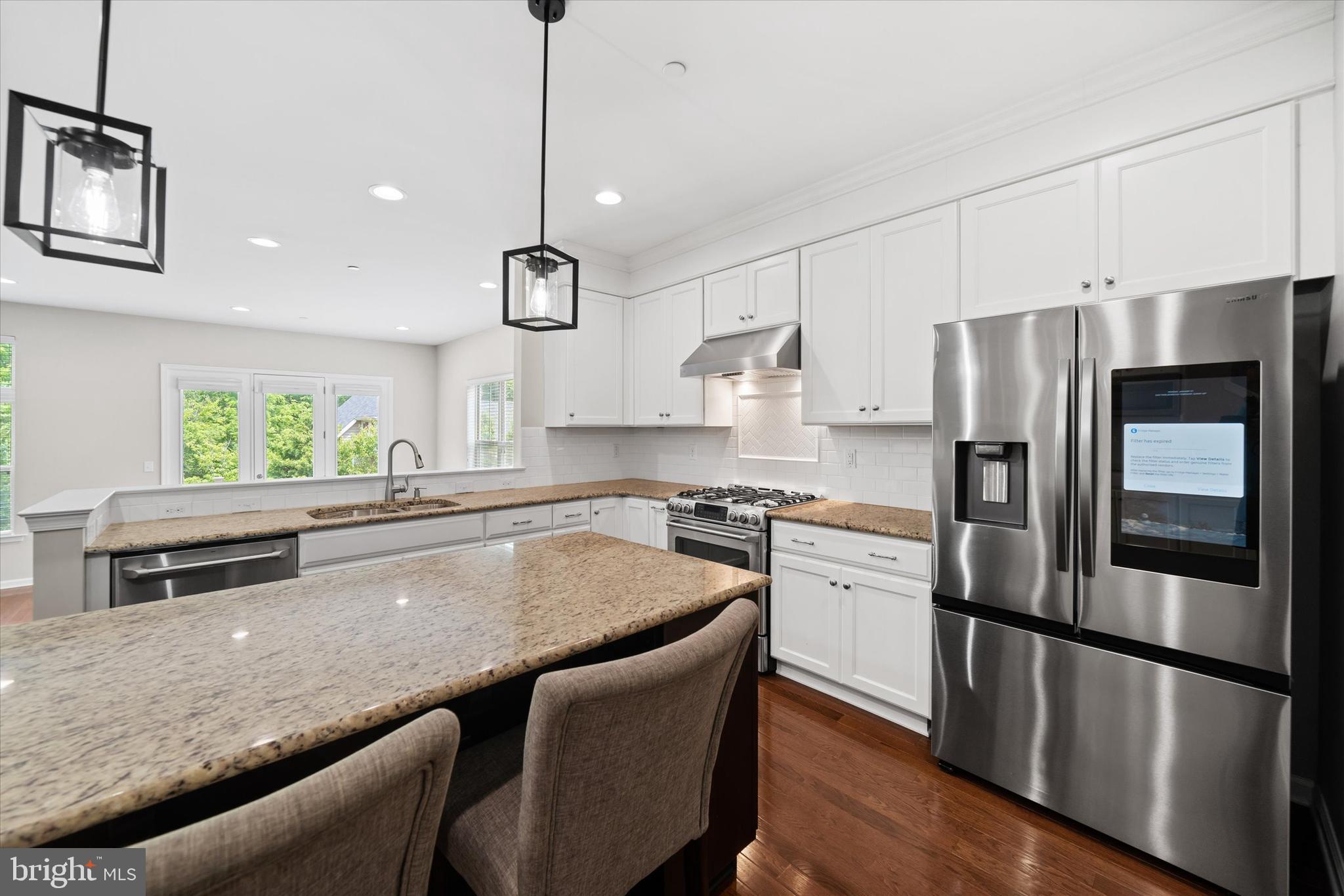 10 Chasmere Drive Kennett Square, PA 19348 - Photo 11 of 49 a kitchen with stainless steel appliances granite countertop a refrigerator a sink dishwasher a stove and white countertops with wooden floor
