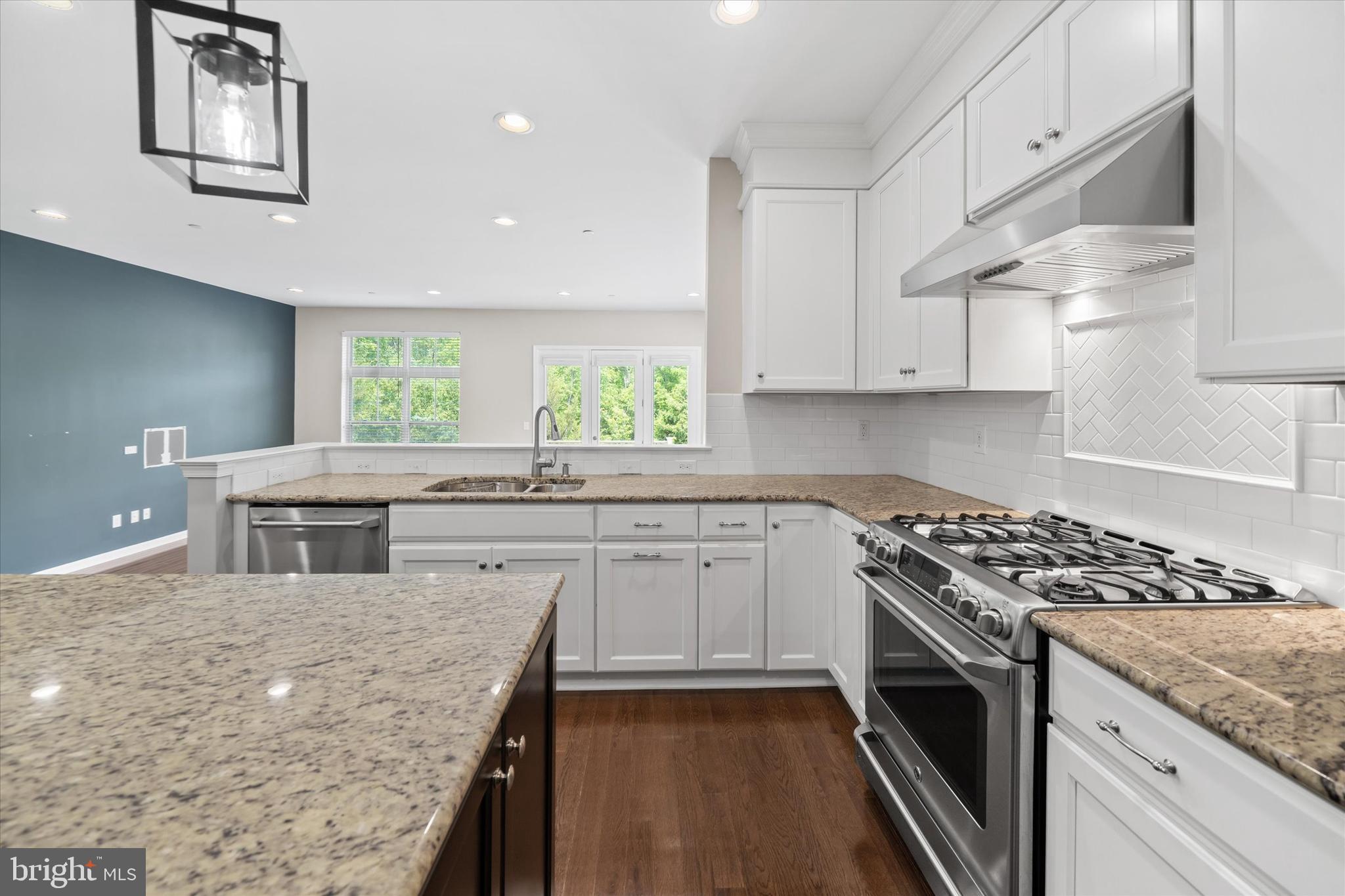 10 Chasmere Drive Kennett Square, PA 19348 - Photo 12 of 49 a kitchen with stainless steel appliances granite countertop a sink stove and cabinets