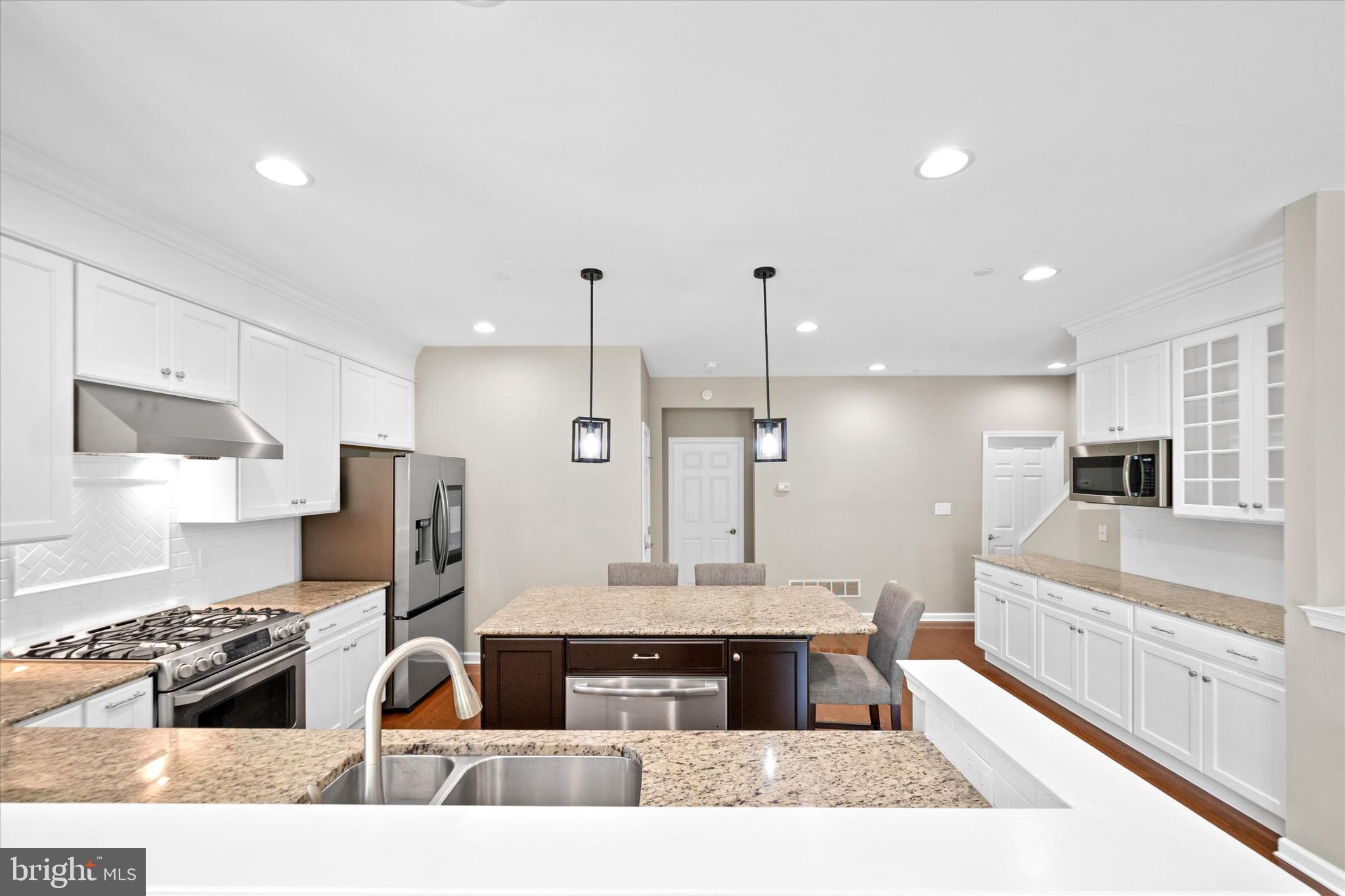 10 Chasmere Drive Kennett Square, PA 19348 - Photo 15 of 49 a large kitchen with stainless steel appliances kitchen island granite countertop a stove and refrigerator