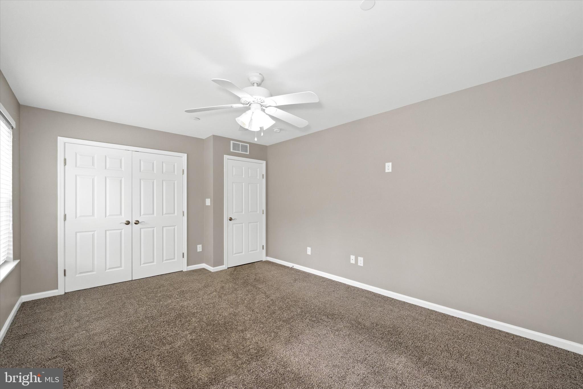 10 Chasmere Drive Kennett Square, PA 19348 - Photo 39 of 49 an empty room with a ceiling fan and a window