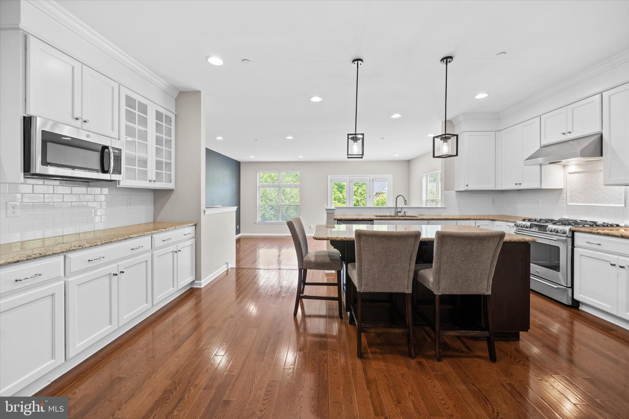 10 Chasmere Drive Kennett Square, PA 19348 - Photo 10 of 49 a kitchen with stainless steel appliances granite countertop a stove a sink a microwave a center island and furniture