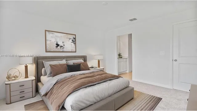 a bedroom with a bed and a painting on the wall