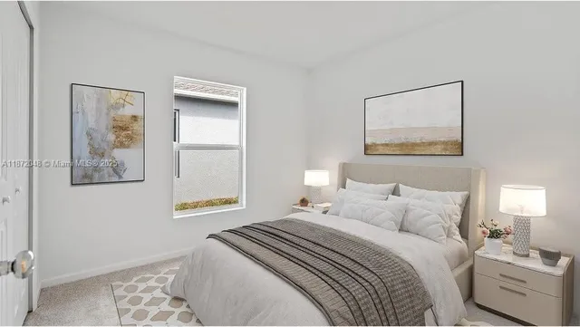 a bedroom with a bed and a painting on the wall