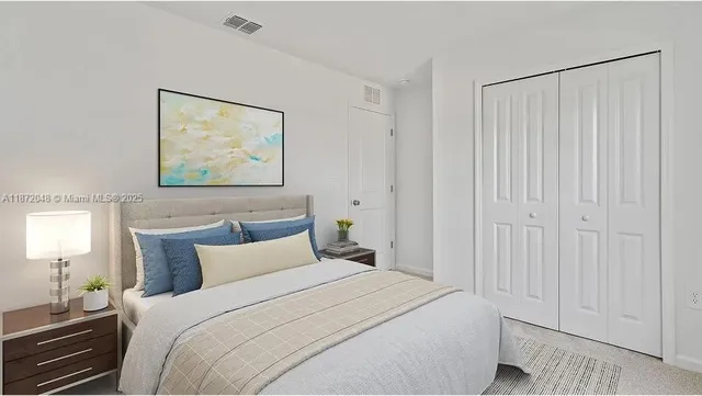 a bedroom with a bed and a painting on the wall