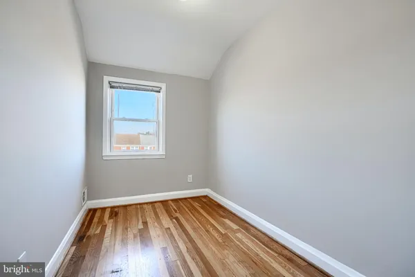 a view of a room with wooden floor and window
