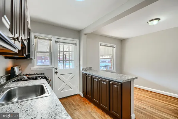 a kitchen that has a sink and a stove in it