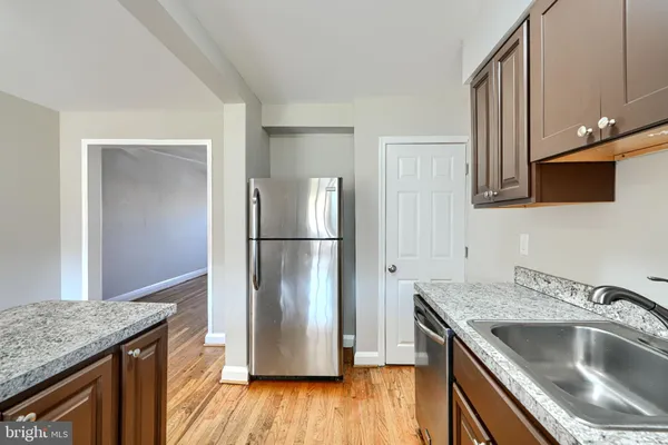 a kitchen with kitchen island a sink stove and refrigerator