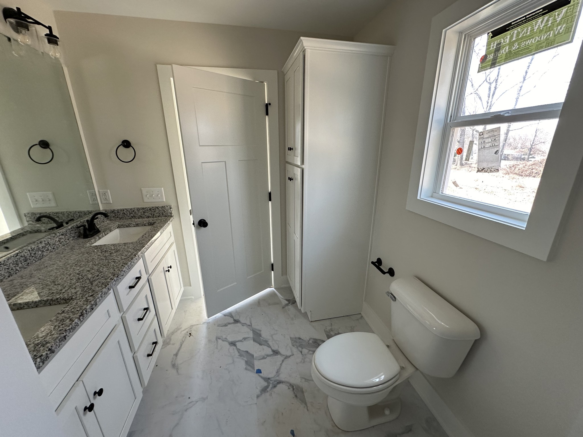 345 Jim Courtney Road Portland, TN 37148 - Photo 7 of 14 a spacious bathroom with a granite countertop toilet sink and mirror