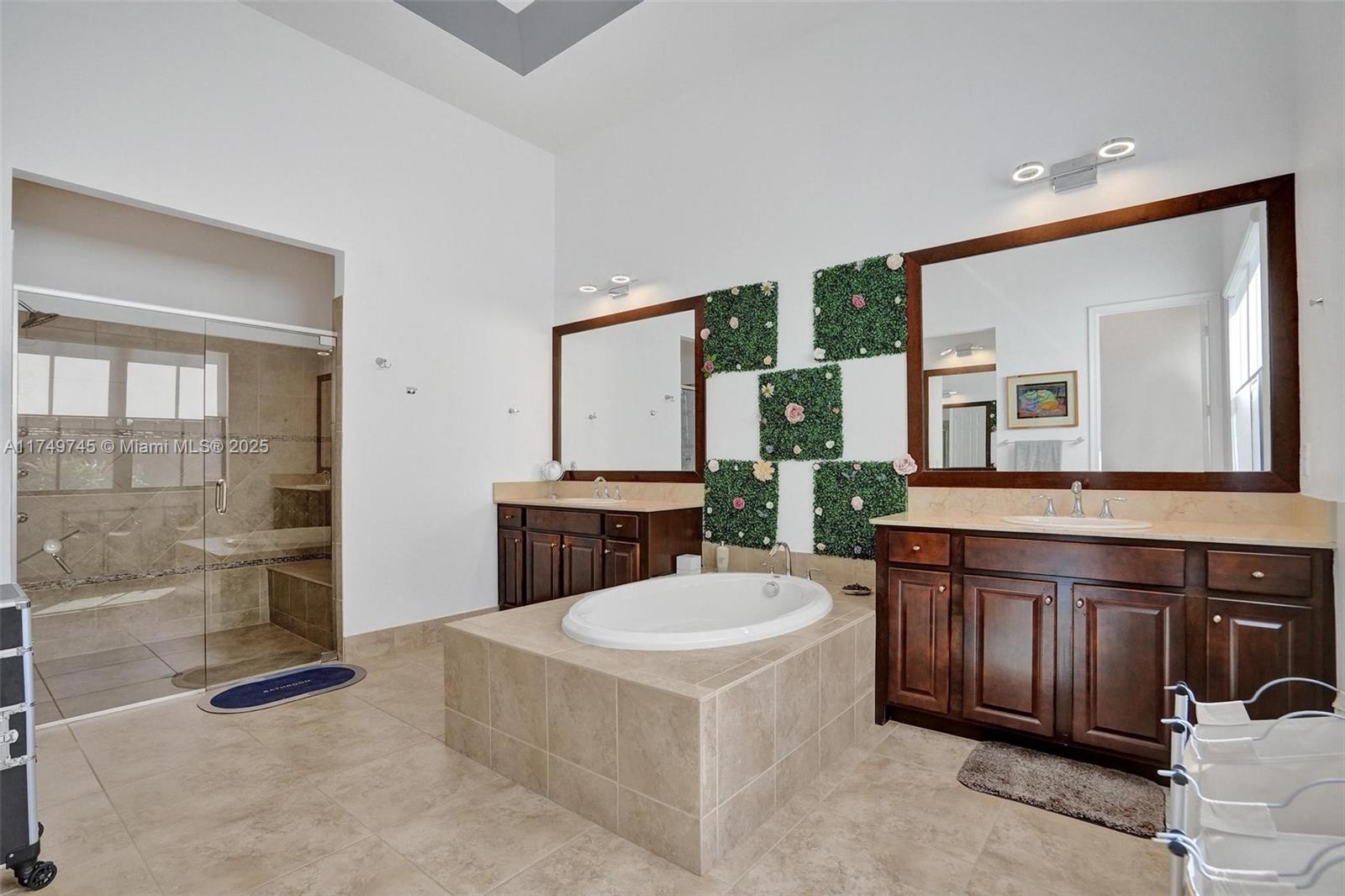 4455 Parkside Road Davie, FL 33328 - Photo 12 of 66 a spacious bathroom with a tub a sink and mirror