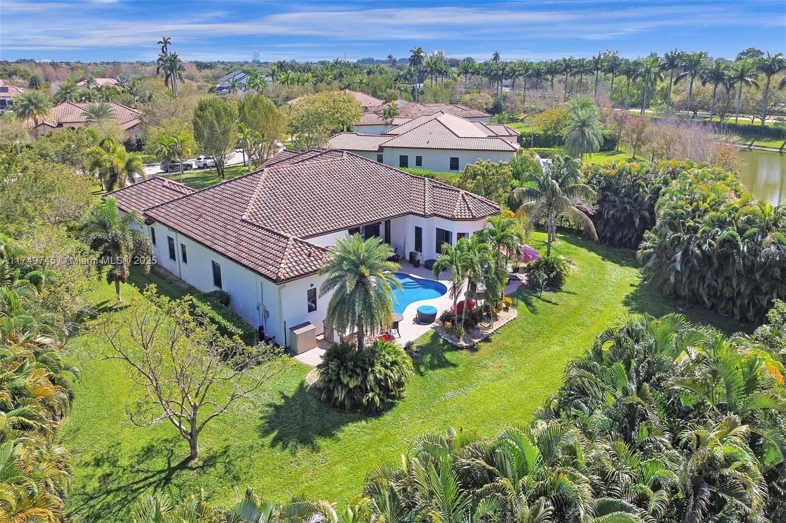 4455 Parkside Road Davie, FL 33328 - Photo 2 of 66 an aerial view of a house with a garden and lake view