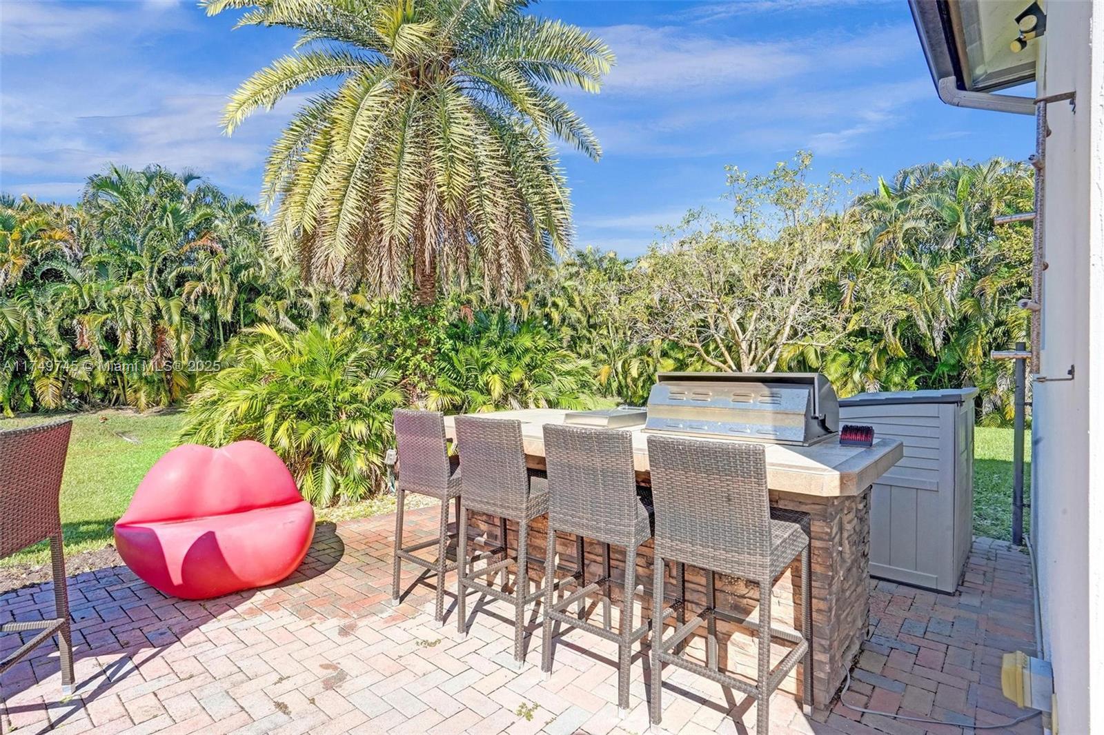 4455 Parkside Road Davie, FL 33328 - Photo 47 of 66 a patio with table and chairs and potted plants