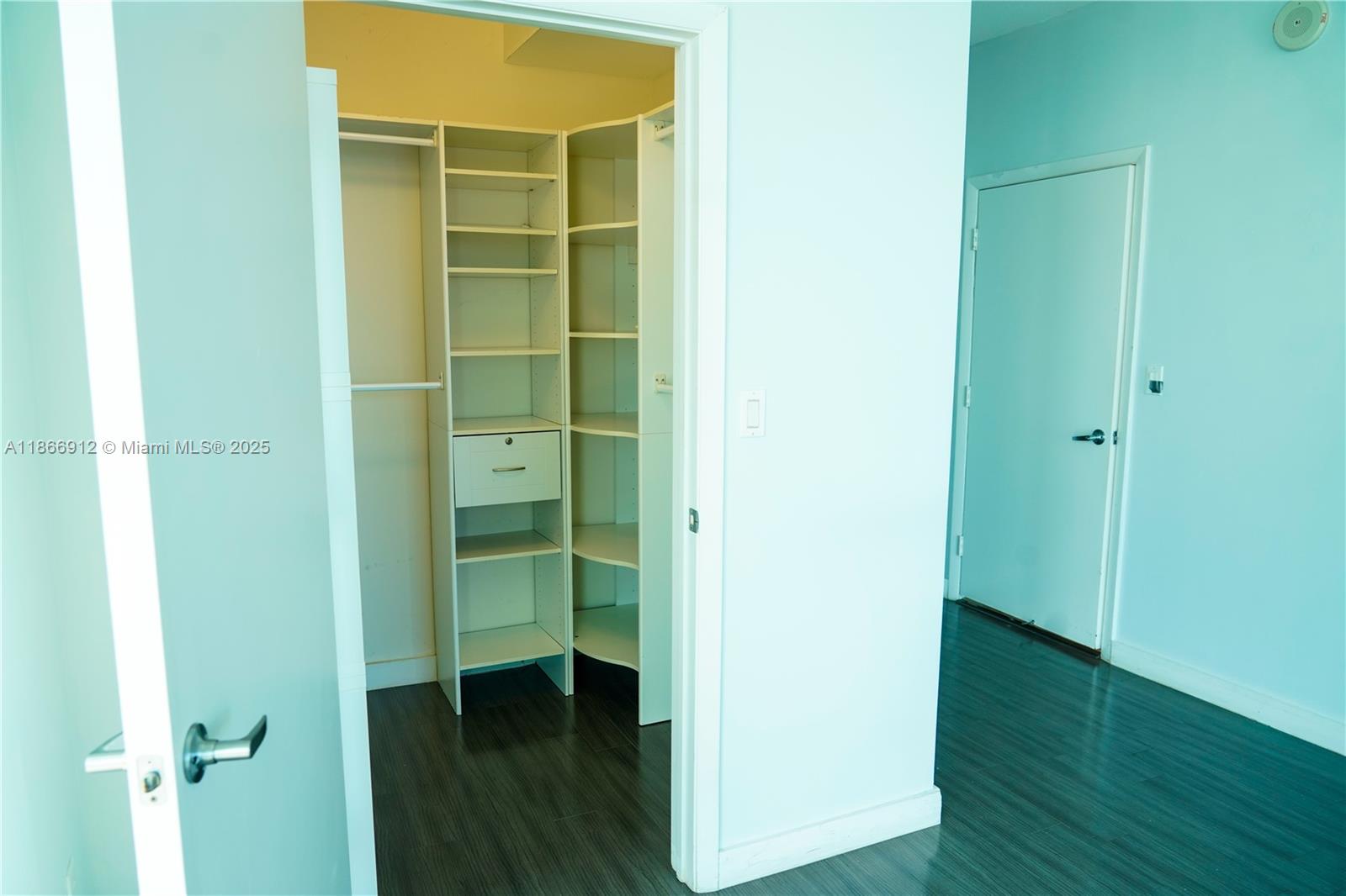 Edgewater Miami, FL 33132 - Photo 24 of 52 a view of walk in closet with wooden floor