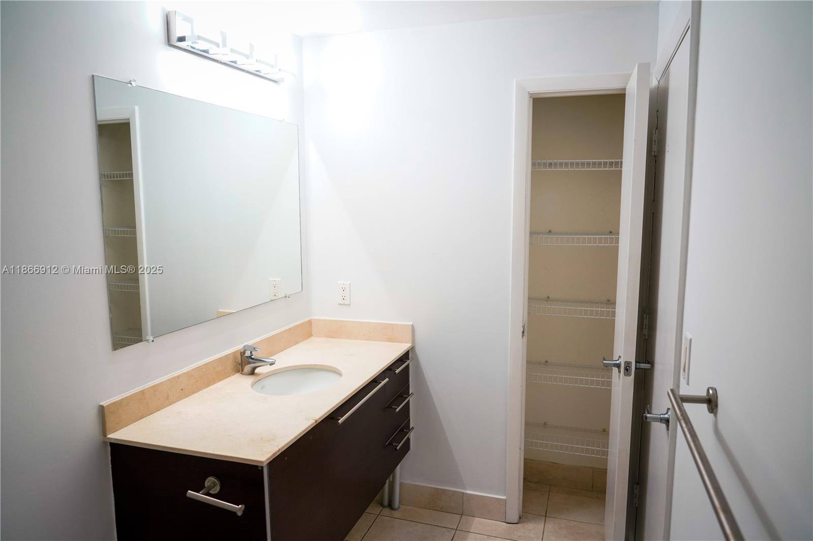 Edgewater Miami, FL 33132 - Photo 31 of 52 a bathroom with a sink vanity and a mirror