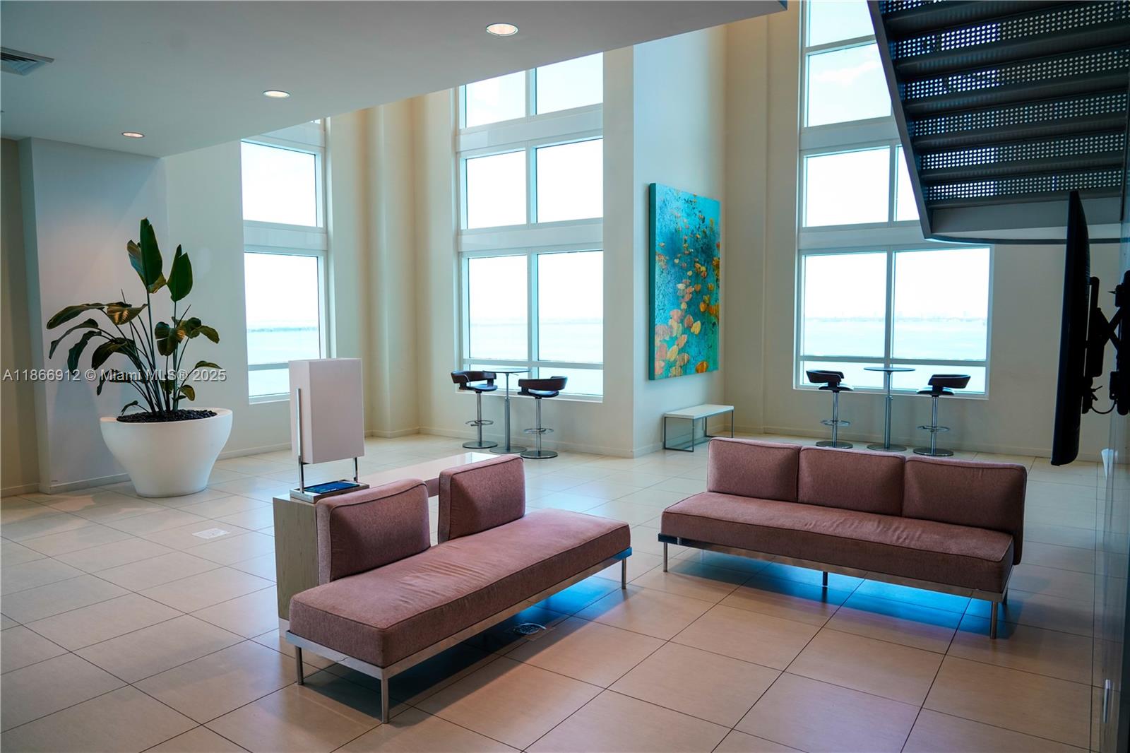 Edgewater Miami, FL 33132 - Photo 36 of 52 a living room with furniture and a potted plant