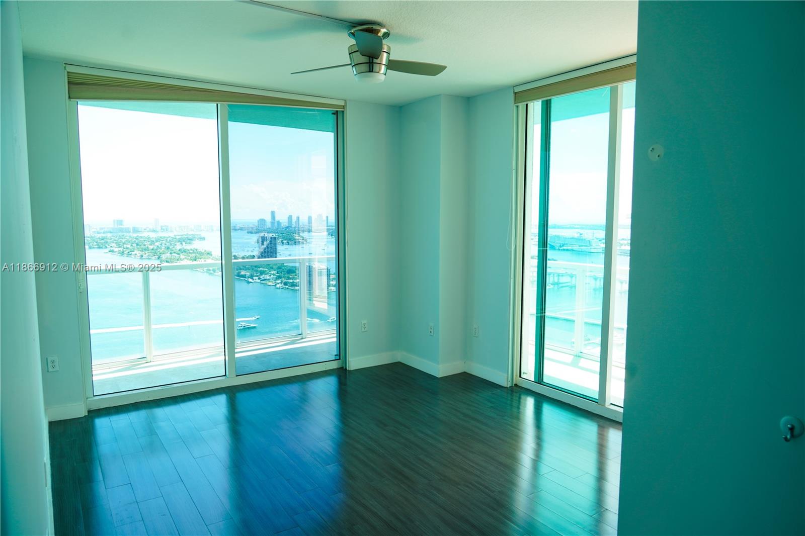 Edgewater Miami, FL 33132 - Photo 46 of 52 a view of an empty room with wooden floor and a window