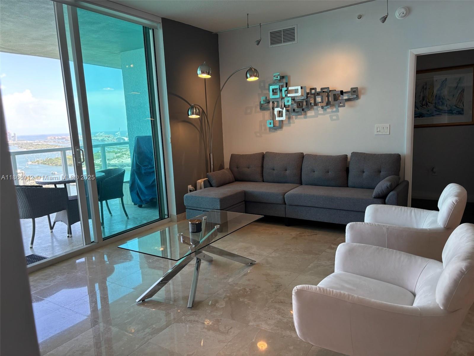 Edgewater Miami, FL 33132 - Photo 5 of 52 a living room with furniture and a floor to ceiling window