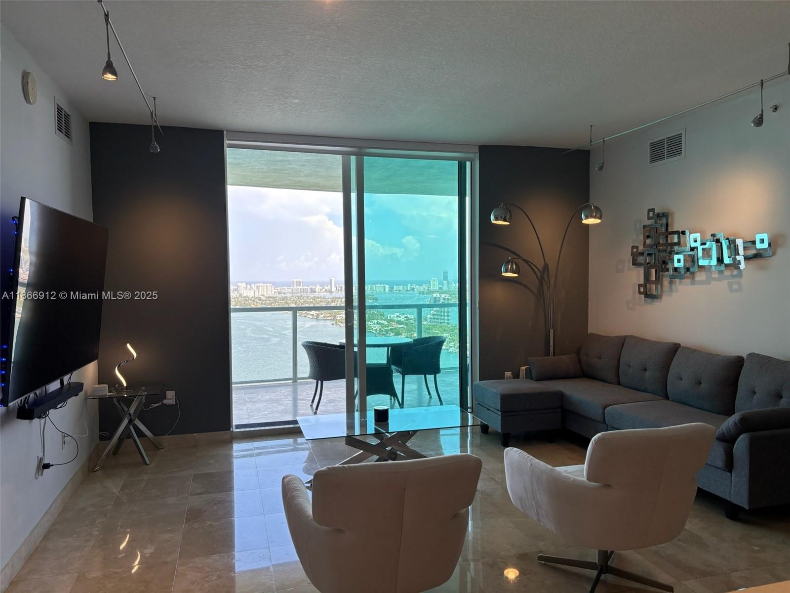 Edgewater Miami, FL 33132 - Photo 6 of 52 a living room with furniture and a flat screen tv