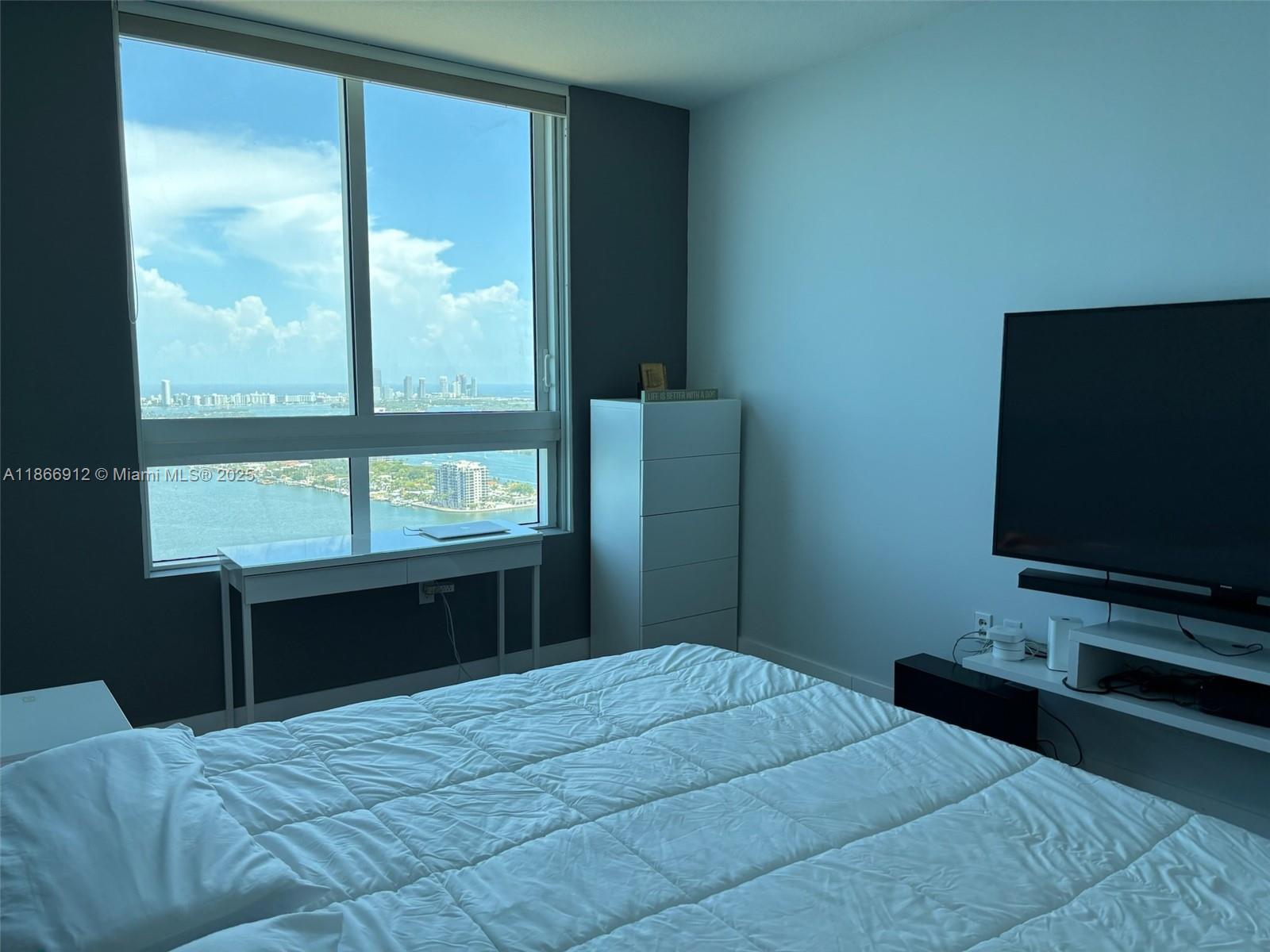 Edgewater Miami, FL 33132 - Photo 8 of 52 a bedroom with a bed and large window