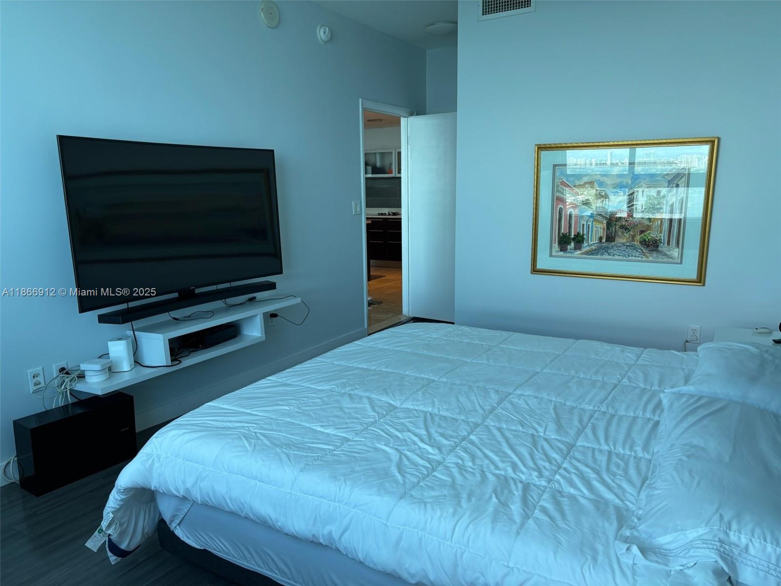 Edgewater Miami, FL 33132 - Photo 10 of 52 a bedroom with a bed and a flat screen tv