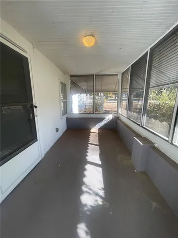 a view of an empty room with a fireplace and a window
